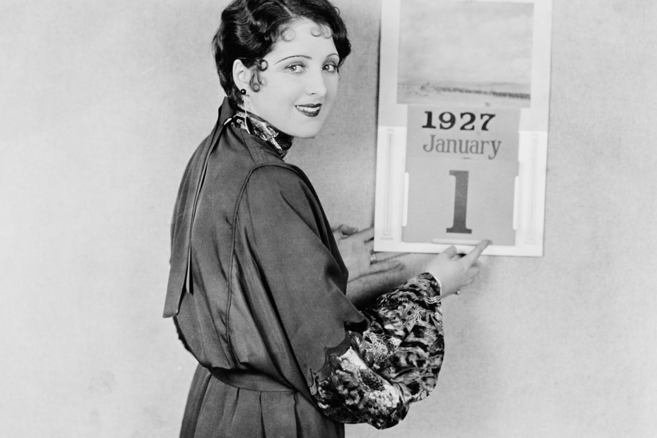 Photographie ancienne d'une femme devant un calendrier