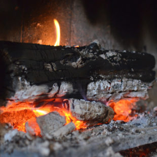 Bûche en train de se consommer dans une cheminée